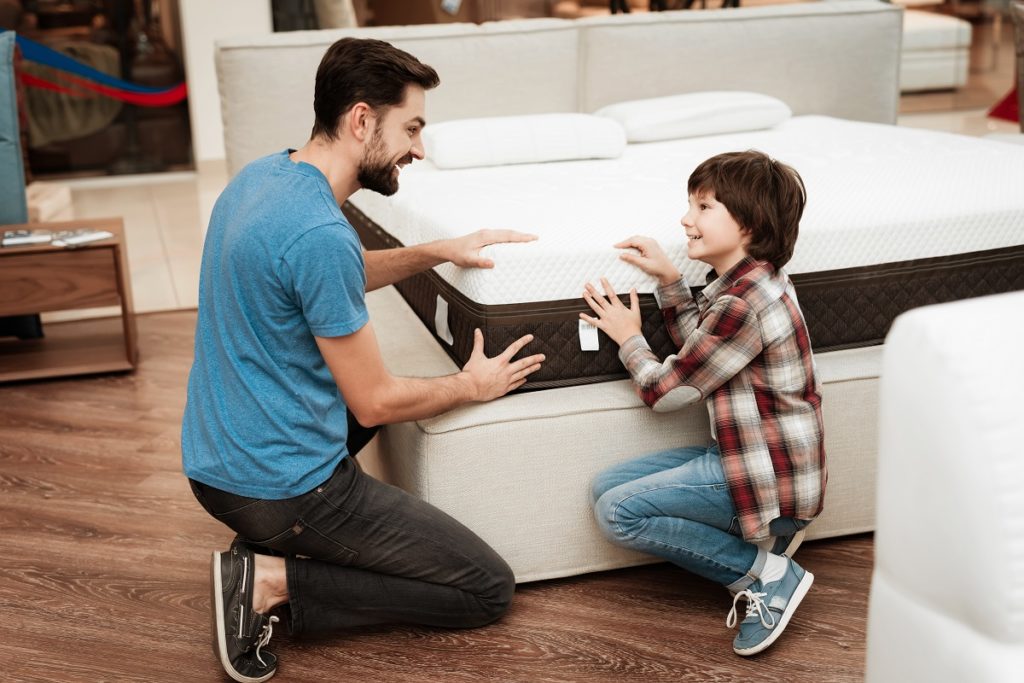 Father and son choosing a mattress