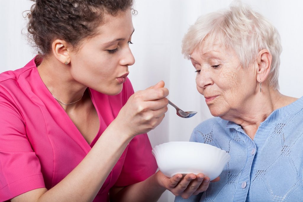 nurse feeding elderly