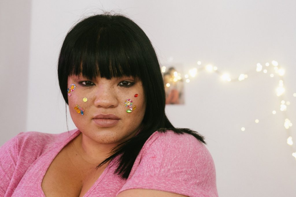 woman with colorful stickers on her face