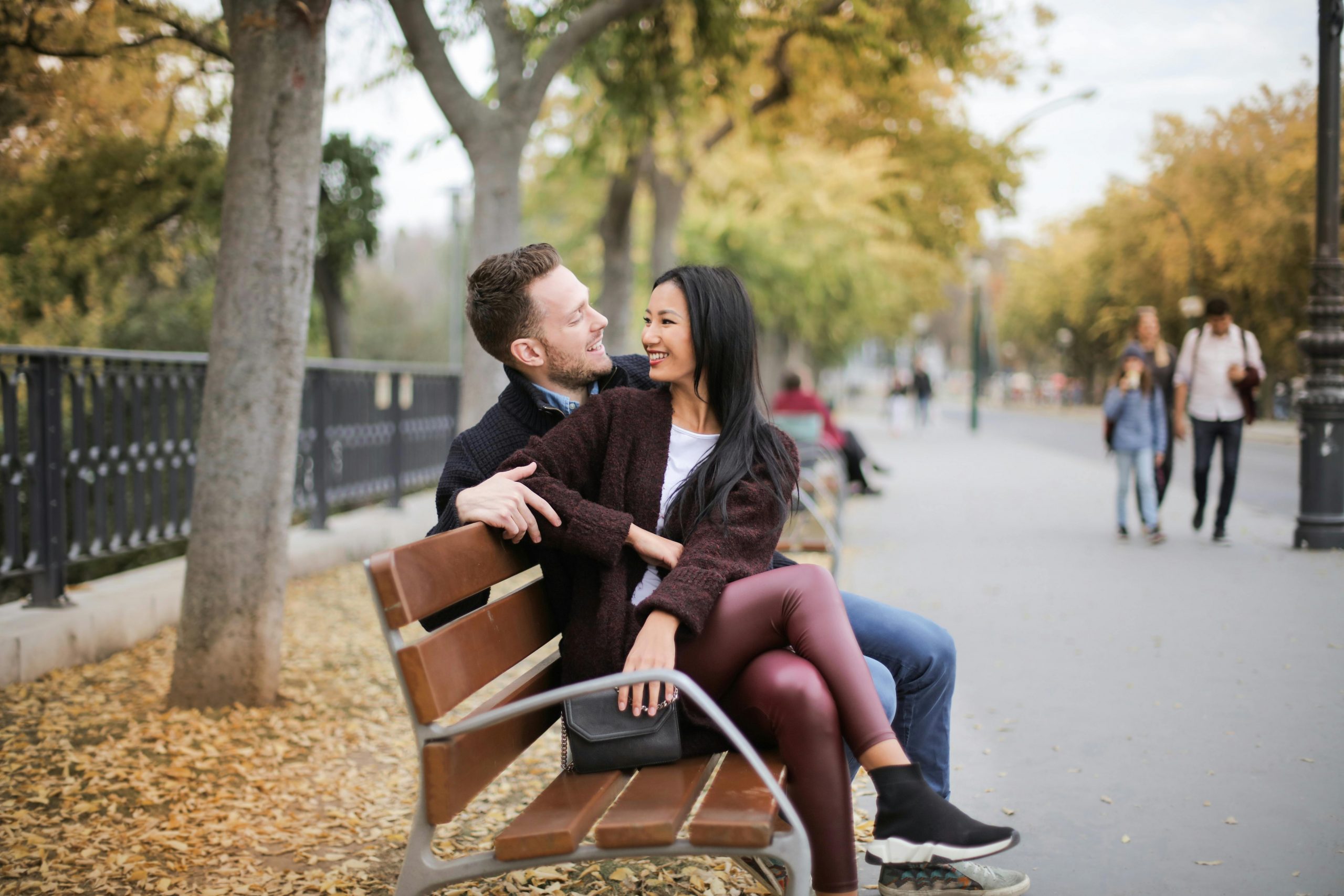 couple sitting on a bench in a park
